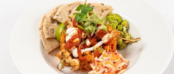 Mexican spiced chicken with a tomato rice and flat bread with roasted cauliflower and a dry slaw - S